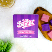 Box of Bath Bombs with 'Brown Sugar & Fig' flavor on a white surface with bath bombs.